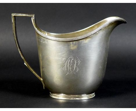 A George III silver milk jug, of helmet form with reeded rim and handle decoration, monogram engraved, John Emes, London 1806