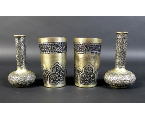 A pair of Cambodian Khmer silver beakers and two bottle vases, all finely decorated with chased and repousse work, the beaker