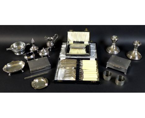 A group of silver and silver plated items, comprising a pair of silver weighted dwarf candlesticks, each 9 by 10cm, a pair of