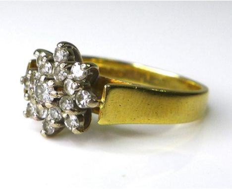 An 18ct gold and diamond flowerhead ring, formed as a chrysanthemum with a double row of diamonds surrounding a central diamo