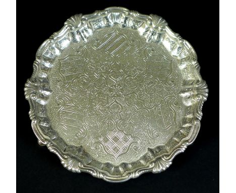 A George II silver waiter tray, of circular form with Chippendale pie crust edge, likely later chased and engraved decoration