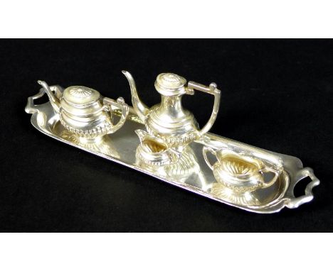 An Elizabeth II silver miniature tea and coffee service, comprising a teapot with lid, 5.3 by 2.2 by 3cm high, a coffee pot w