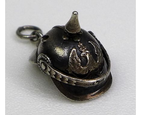 A silver novelty charm, early to mid 20th century, in the form of a WWI German Pickelhaube, finely modelled with movable chin