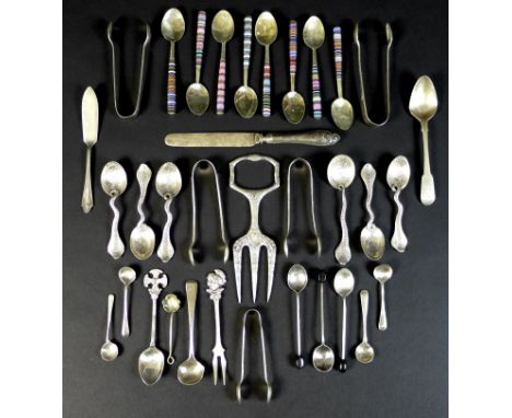 A group of silver and white metal cutlery, including five silver sugar nips, teaspoons, salt spoons, coffee spoons, a set of 