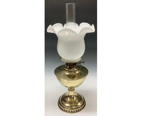 A 19th century brass oil lamp, white opaque glass fluted shade, with chimney 
