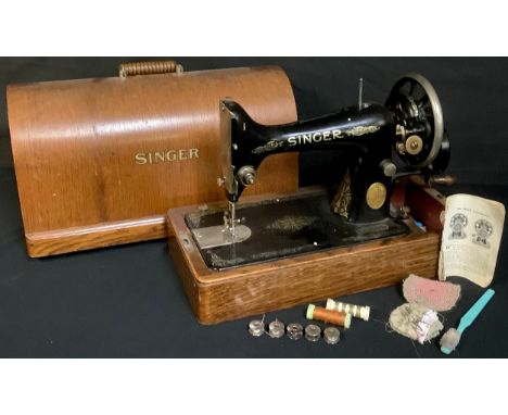 A manual Singer sewing machine in oak carry case 