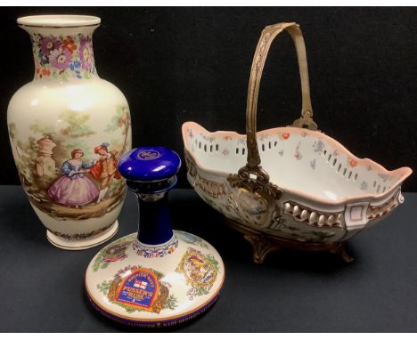 A large porcelain basket, pierced rim, printed with flowers, brass mounted swing handle, 37.5cm wide; a Chinese export ware c