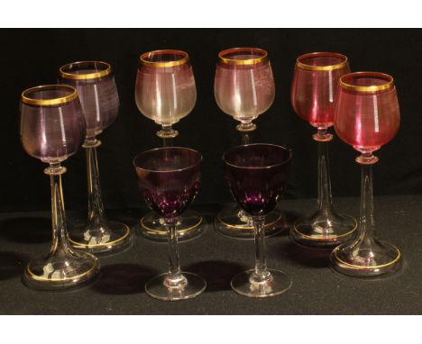 A set of six tulip shaped hock wine glasses, the ribbed bowls in shades of pink and amethyst, slender hollow tapering stems, 