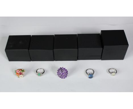 Five boxed silver and gemstone dress rings, set with emerald, amethyst, blue topaz and ruby. Various designs and sizes. Stamp