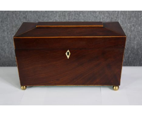 A Regency mahogany and satinwood strung tea caddy with fitted lidded compartments and a mixing bowl. H.18 W.30 D.16cm. 