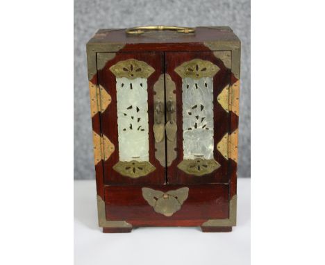 A Chinese 20th century jewellery box with carved and pierced jade panels, brass fittings with two doors to reveal five drawer