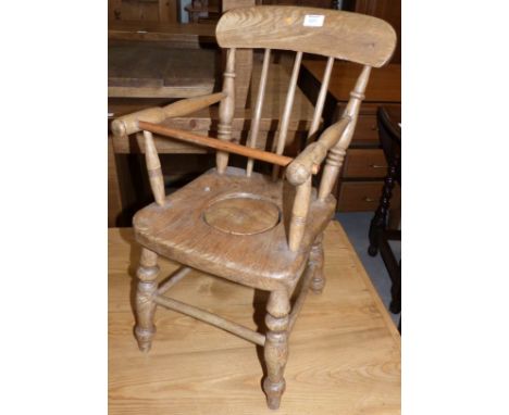 A 19th century child's elm and beech stick back potty chair