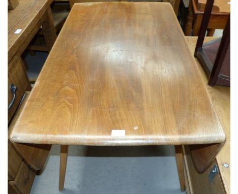 An Ercol lightwood drop leaf dining table, extended length 49"