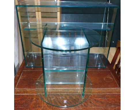 A modernist glass occasional table; table lamp; display shelves