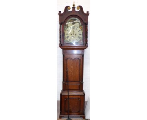 An early 19th century crossbanded oak longcase clock with brass finial and paterae, swan neck pediment and turned columns to 