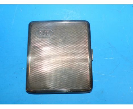 A silver engine turned cigarette case