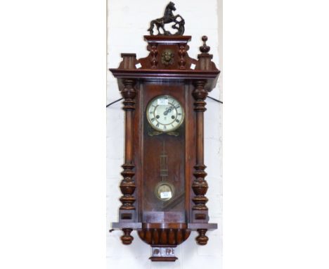 A 19th century walnut cased Vienna wall clock with horse finial and striking spring driven movement