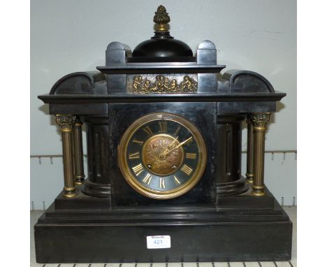 A large 19th century French black marble mantel clock with striking movement