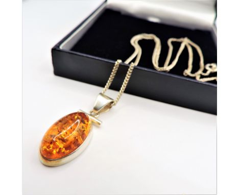 Sterling Silver Baltic Amber Pendant Necklace. A fine quality sterling silver pendant necklace set with a vibrant oval 20x12m