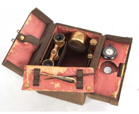 A ladies vintage leather travelling vanity case, contents to include gilt metal scent bottle, needle case, pill box, comb, op