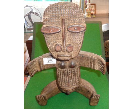 Tribal Art: African carved wood fertility figure of a seated woman with outstretched arms