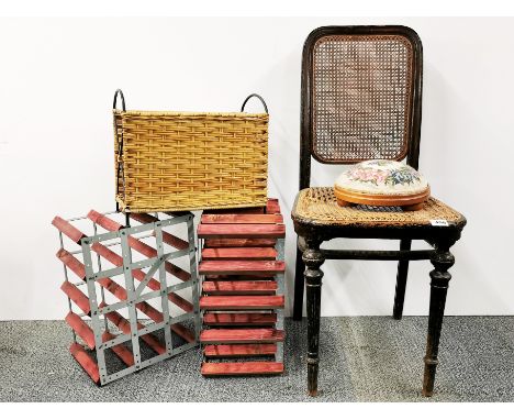 A Victorian cane seated chair, tapestry, footstool, magazine rack and two wine racks.