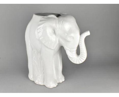 A Large White Glazed Ceramic Stick Stand in the Form of an Elephant, 44cms High 