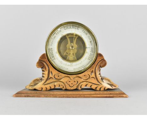 A Late 19th Century Brass Circular Aneroid Barometer Mounted on Carved Wooden Stand, 21.5cms Wide 