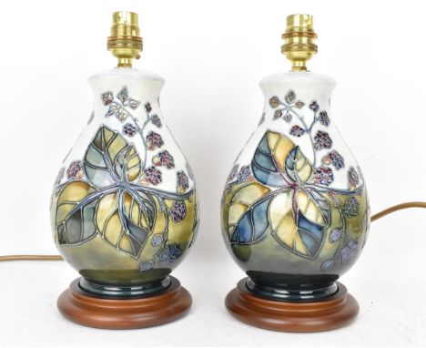 A pair of Moorcroft pottery 'Bramble' pattern table lamps, each of baluster form tube lined with berries and leaves, in autum
