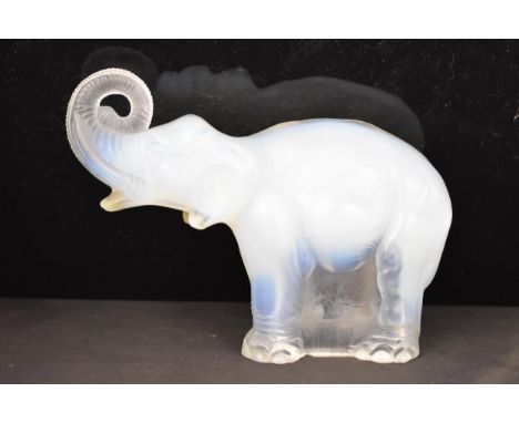 Attributed to James A. Jobling &amp; Co - An Art Deco opalescent glass moulded model of an elephant, standing four square wit