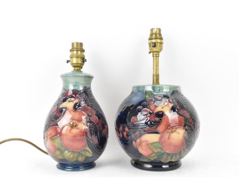 Two Moorcroft pottery 'Finches and Fruit' pattern table lamps, designed by Sally Tuffin, each of baluster form and on a blue 