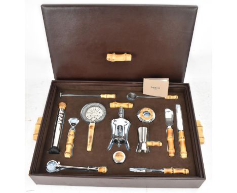A Lorenzi Milano Italian brown leather cased bar set, comprising a double lever corkscrew, cap lifter, champagne opener and s