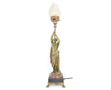 A late 19th century French bronze figural table lamp, fashioned as a classical maiden holding a torch above her head, having 