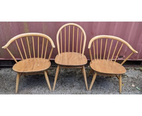 Three mid 20th century Ercol light elm and beech chairs to include a single hoop back dining chair and a pair of 'cow horn' a