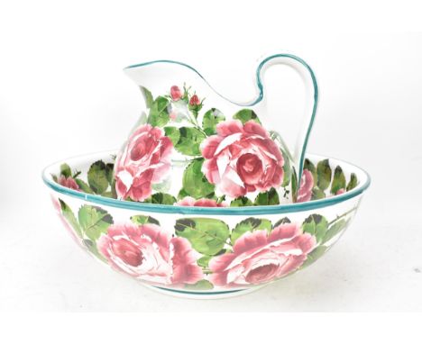 An early 20th century Wemyss 'Cabbage Roses' pattern wash jug and bowl, painted in polychrome with flowers, by Joseph Nekola,