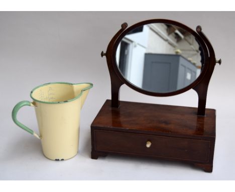 A small adjustable toilet mirror with single drawer below and a vintage enamel measuring jug