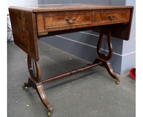 A sofa table with two drawers, drop ends, raised on lyre supports joined by a central turned stretcher, 54x76cmH