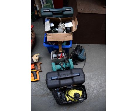 A box of tools including two bench grinders, an electric drill, sander and circular saw and a steam cleaner