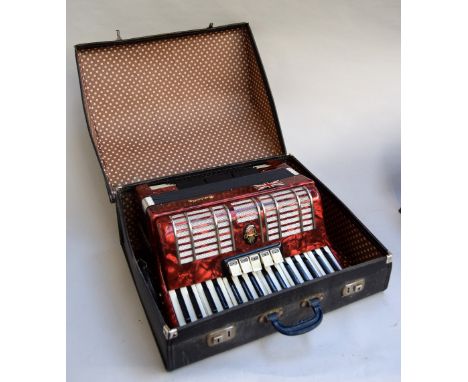 A Galotta `Ideal` Piano Accordion no. 016553, in red with white keyboard, with music, cased