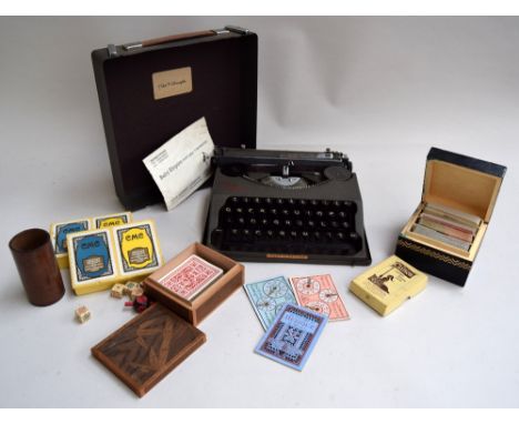 The Baby Empire portable type writer in case with instructions together with various playing cards and gaming dice