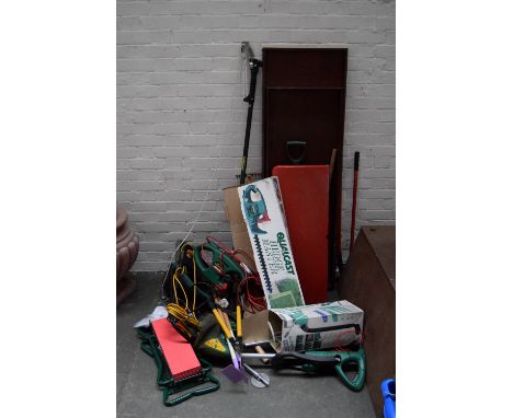 A collection of garden tools including a hedge trimmer, flymo, loppers, shears etc