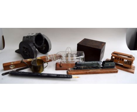 A brass trivet, glass model of the Cutty Sark, period Battle of Britain and similar publications, wooden canon, wooden model 