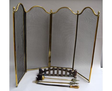 A three-fold four screen brass fireguard with acorn finials 82cmH and a mixed brass companion set including Mr Punch and a sm