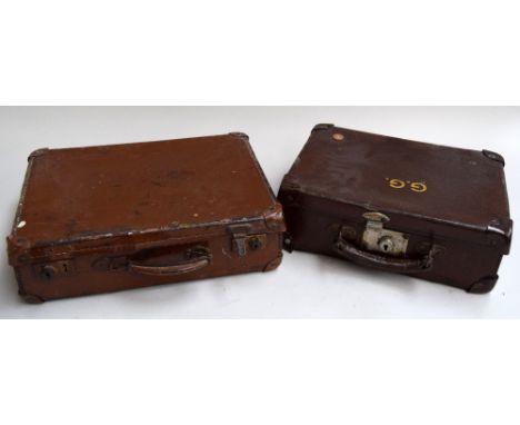 Two small brown vintage suitcases, one with an HMS York pennant and print blocks