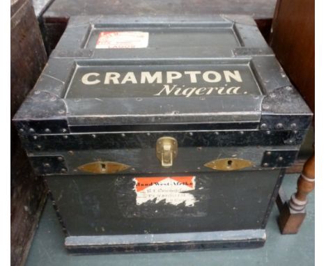 A metal lined travel trunk of painted pine with metal bracings and side handles and African shipping lables and inscribed 'CR