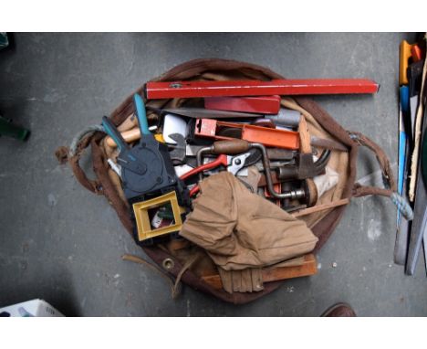 A bag of mixed tools and hand saws