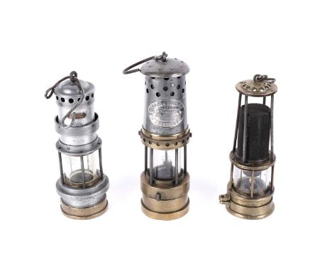 Three miners’ lamps by E. Thomas and Williams Aberdare, including a ‘Type No. 2 A.F.S.’, 30cms; a No. 21D, 27cms; and a Clann
