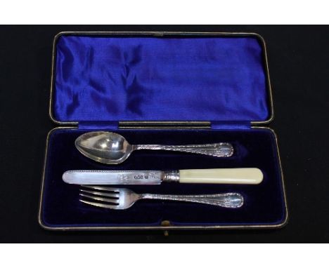 A George V three piece silver knife, fork and spoon set, hallmarked Sheffield 1918. Maker: James Deakin & Sons, in a fitted c