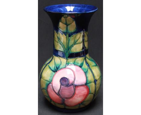 A 1990s Moorcroft 'Rose' vase, designed by Sally Tuffin, with tube-lined decoration of pink roses with green leaves on a blue