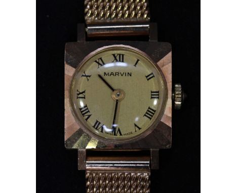 A ladies Marvin 9ct gold wristwatch with ruby mounted winder and 9ct mesh bracelet.
